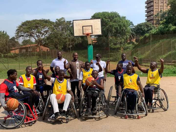 Athletes in a basketball court during a sports project for persons with disabilities by Disability People's Forum Uganda.